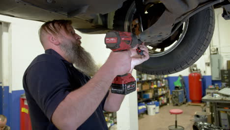 man maintenance of his car in a garage