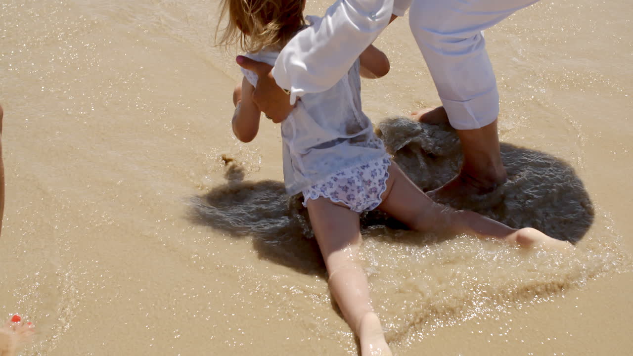 Little girl paddling in the surf