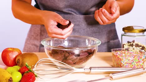 preparing chocolate discs with fruit and sprinkles