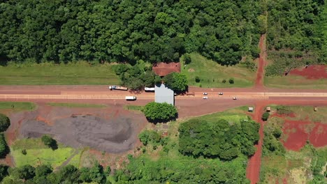 Two-way-highway-where-different-vehicles-pass-seen-from-above-by-a-drone-in-Misiones,-Argentina