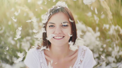 portrait of a young woman looks at the camera before her and on her down and down feathers