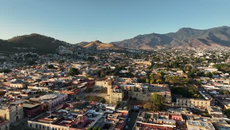 Drone-Shot-of-Oaxaca-Mexico-Downtown-on-Golden-Hour,-Buildings,-Streets-and-Santo-Domingo-Catholic-Church