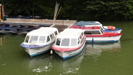 three boats docked at a pier