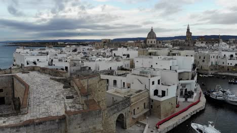 drone slowly flies over monopoli castle and the old city during the dawn