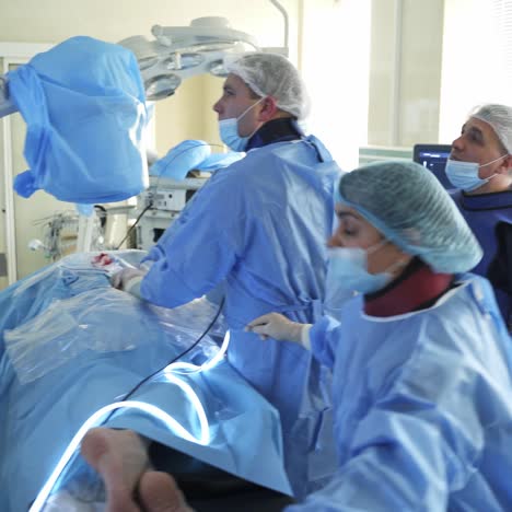 surgeons team looks at monitors. surgical operation using laparoscopic equipment in modern clinic
