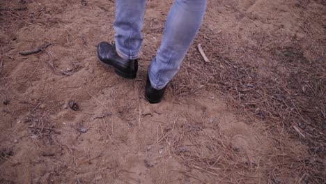 black dress shoes walking through forest