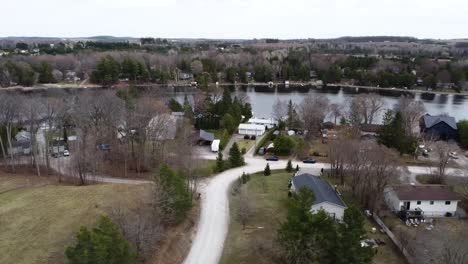 aerial shot circling over lakeside town in the kawartha's in spring