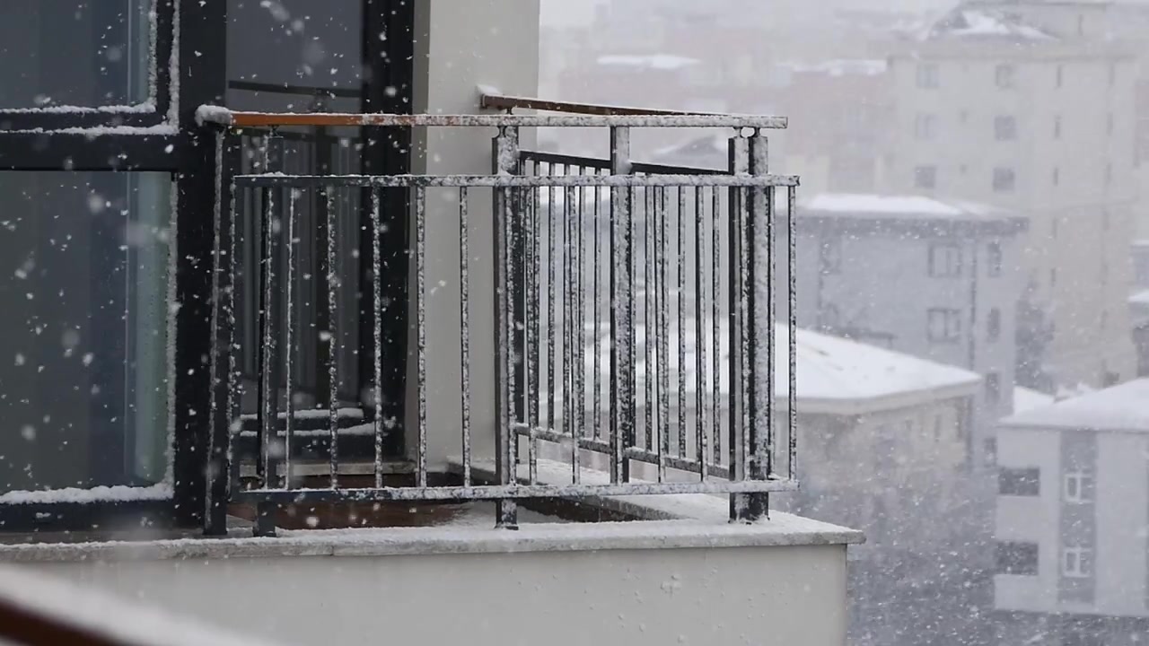 Snow Falling on an Urban Apartment Balcony in Winter