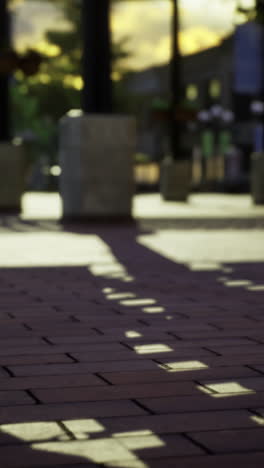 City streets awaken at golden hour with shadows playing across the pavement