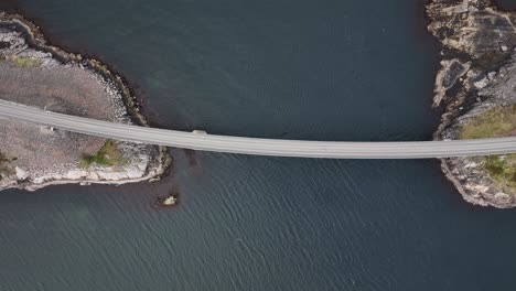 atlantic ocean road - top down aerial view of bridge with atlantic ocean crossing below - coastal birdseye of road and sea