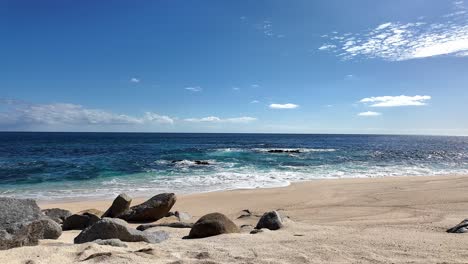 serene beach scene with rocks and blue ocean