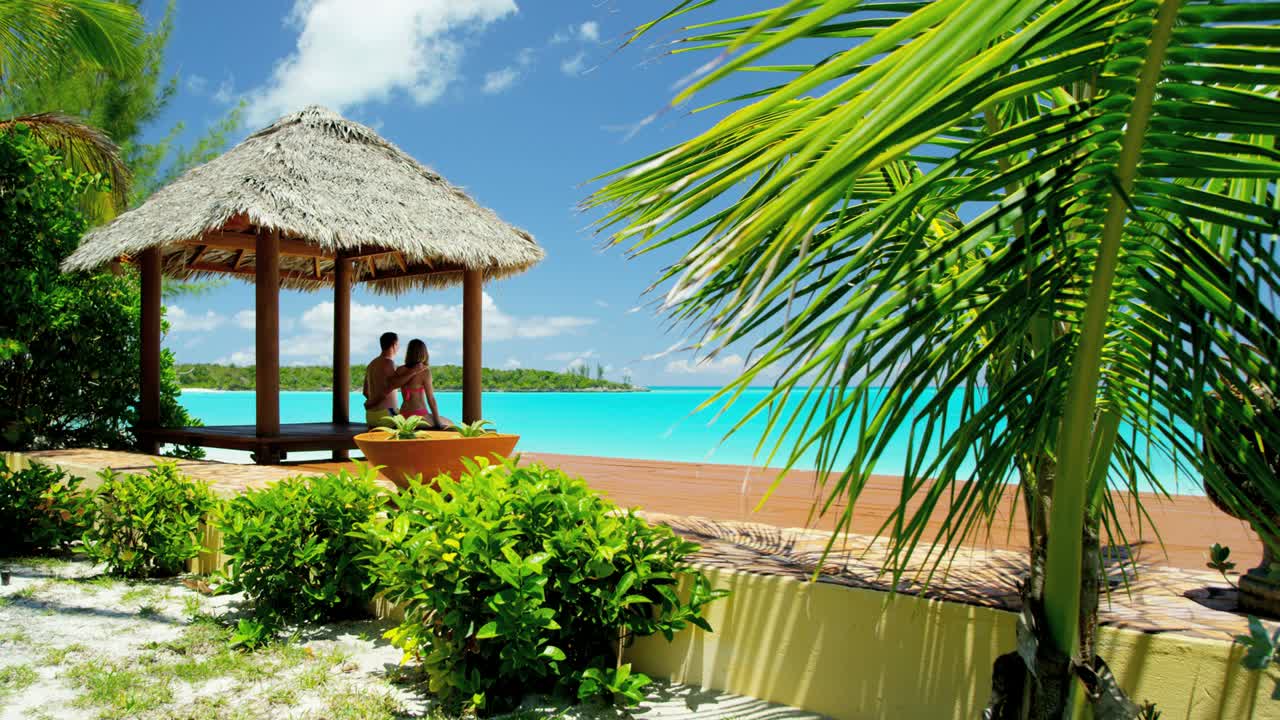 Young Caucasian couple in a tropical beach hut