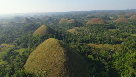 4k drone video flying around the chocolate hills in bohol, philippines