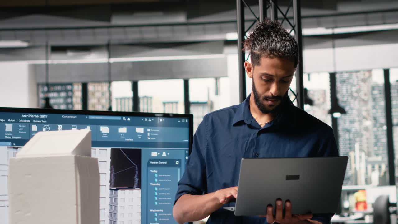 Vertical Video Middle eastern contractor analyzing architectural 3D models to set measurements