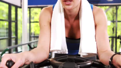 Fit-focused-woman-cycling-on-the-exercise-bike