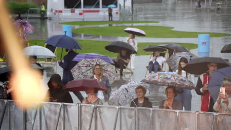 rainy day event with people under umbrellas