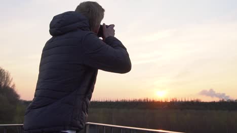 a person is taking photos while standing on a viewing platform-1