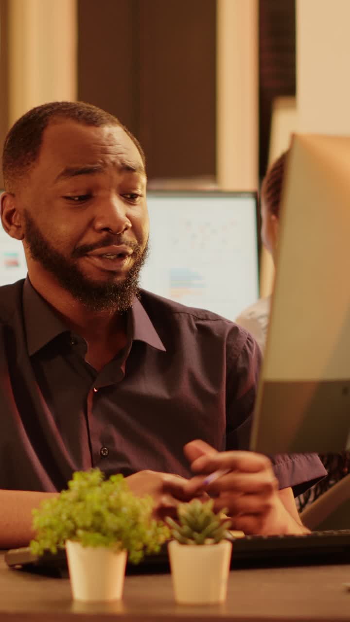 Man in Office Setting Working at Computer