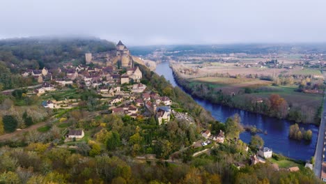 wide aerial view of castelnaud-la-chapelle, medieval village in dordogne with unique castel