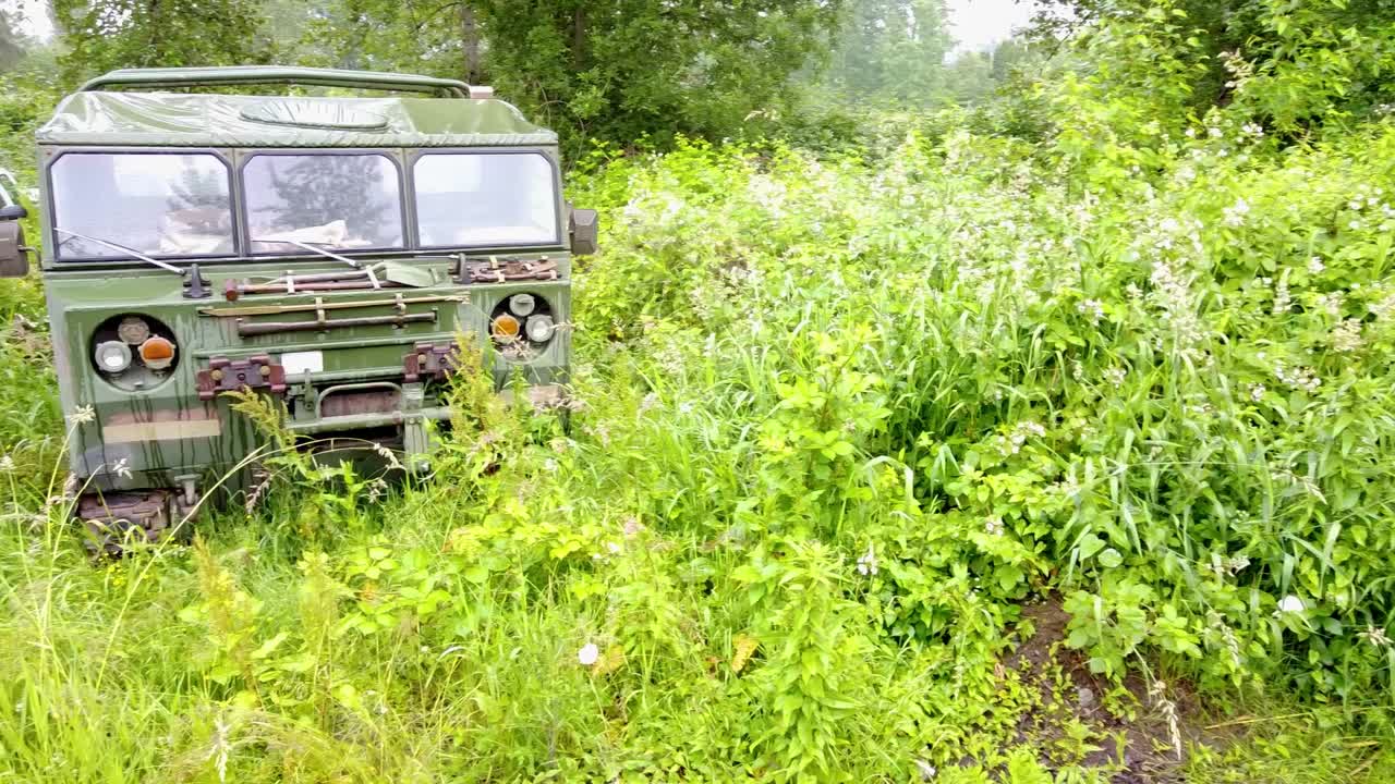 The M548 is a tracked cargo carrier, commonly used to haul military ammunition for tanks. Here its parked in a camouflaged bush area on a wet rainy day.