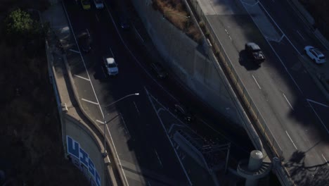 drone shot of los angeles traffic going into and out of the tunnels north of the city.