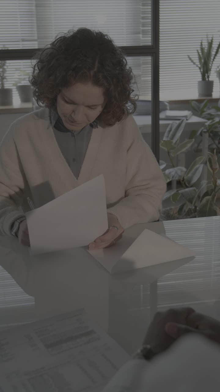 Woman Signing Documents in a Meeting