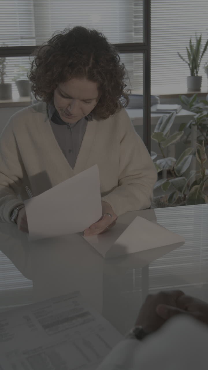 Woman Signing Documents in a Meeting