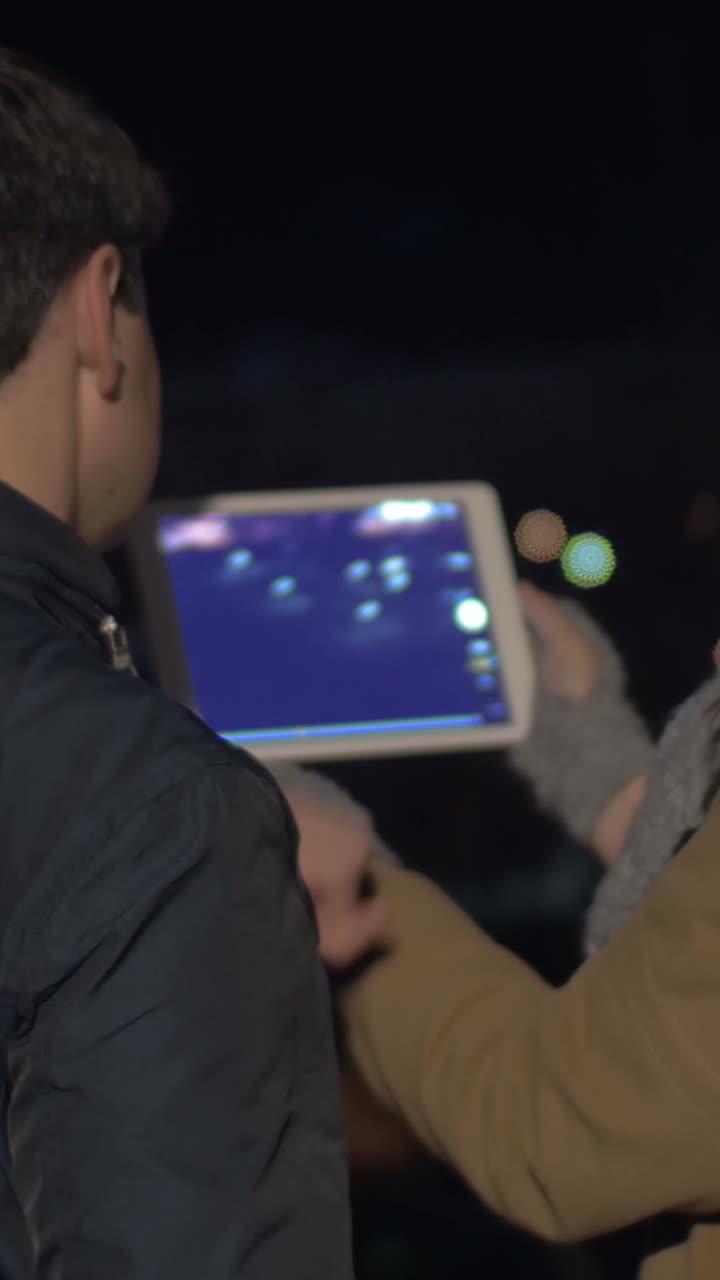 People using a tablet at night