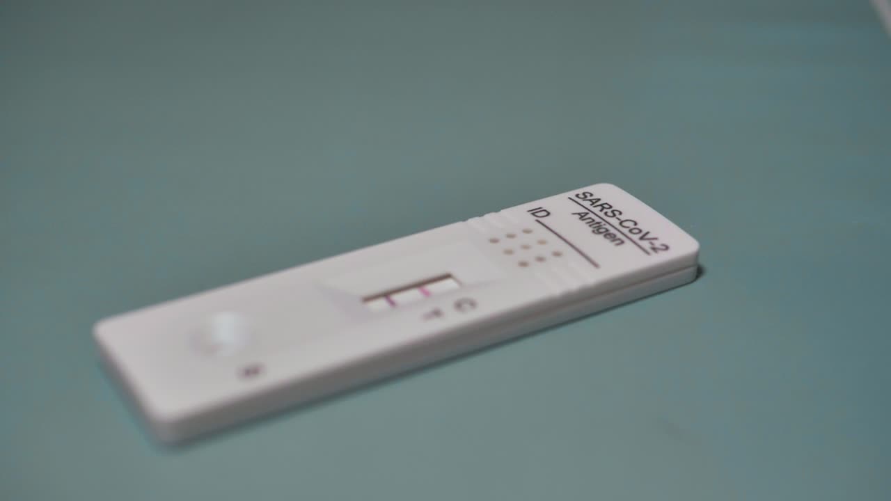 Covid rapid antigen test positive result. Infection, screening and treatment. Slowmotion. Scene E