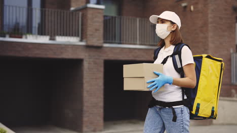 woman delivery person with packages during pandemic