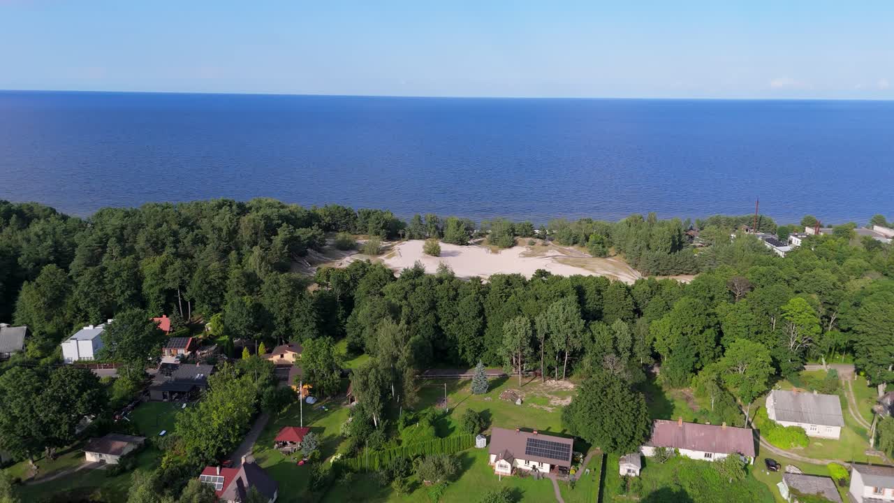 Aerial Drone Footage of Plienciems White Dune in Latvia on a Sunny Summer Day. Scenic Baltic Sea Bay Views, Peaceful Nature, and Coastal Landscape Captured in Cinematic Quality