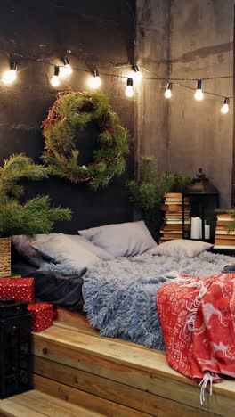 cozy room with christmas decorations. christmas decorated bedroom with many lights and christmas tree. christmas tree with garlands. vertical video