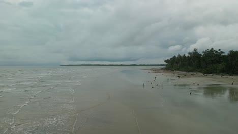 aerial drone view of sempadi beach,during raining season,dark cloud monsoon tropical asian,sarawak,borneo.