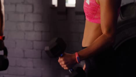 Woman-exercising-with-dumbbell