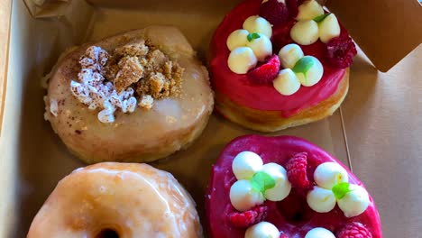 delicious mix of sweet doughnuts with raspberry glaze, cookies and cream, fresh raspberries, deep fried tasty donut snacks, 4k shot