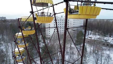 abandoned pripyat city and rusty ferris wheel in winter, chernobyl