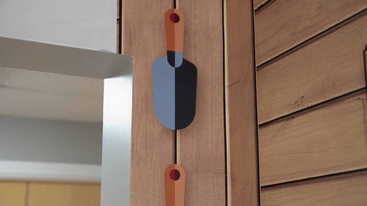 Interior walls of a building have been decorated with vinyl sticker wall art to create a garden like environment in an old peoples care home with pictures of spades ,trowels on the wall with fake wood