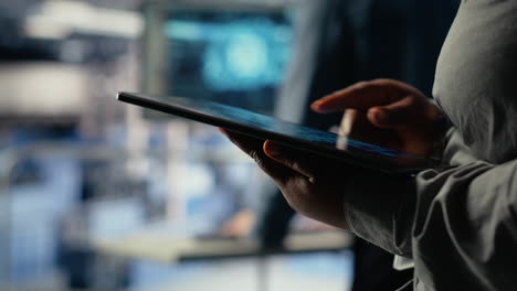data center programmers check ai dashboard using tablet, doing systems review