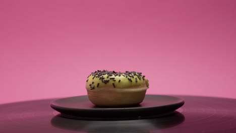 delicious american donut with yellow sweet topping and choco crumbs