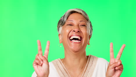 Laughing,-peace-sign-and-face-of-woman-on-green