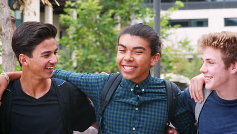 portrait of male high school students outside college buildings
