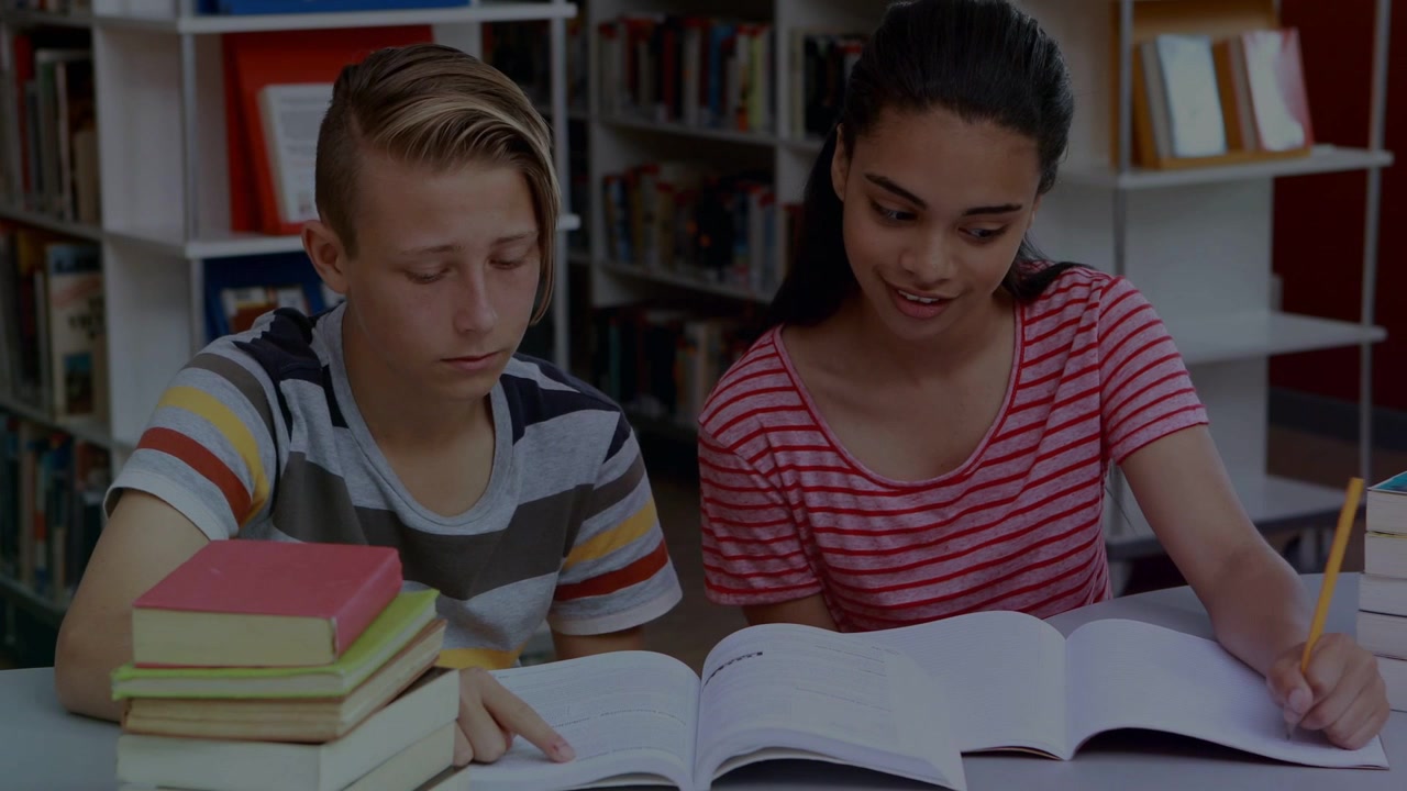 Vertical video: Pointing two teens studying at library in stripes using book, pencils, light specks