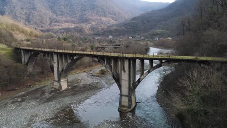 abandoned arch bridge in a mountain valley