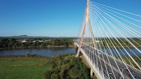 ireland epic locations drone flying along side of francis meagher bridge waterford ireland with traffic on a summer morning