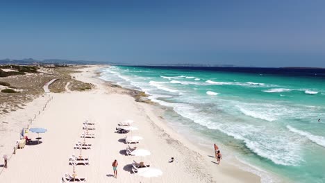 Aerial-drone-shot-of-Formentera-Ibiza-island-with-view-of-beach-and-sea-Boom-up-sunny-summer-day-windy-with-clean-sky