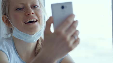 woman using phone at window
