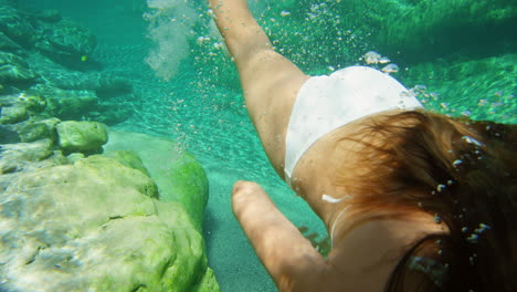 A-woman-in-a-white-bikini-swimming-in-a-lake