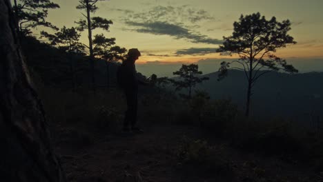 hiker at sunset mountain viewpoint