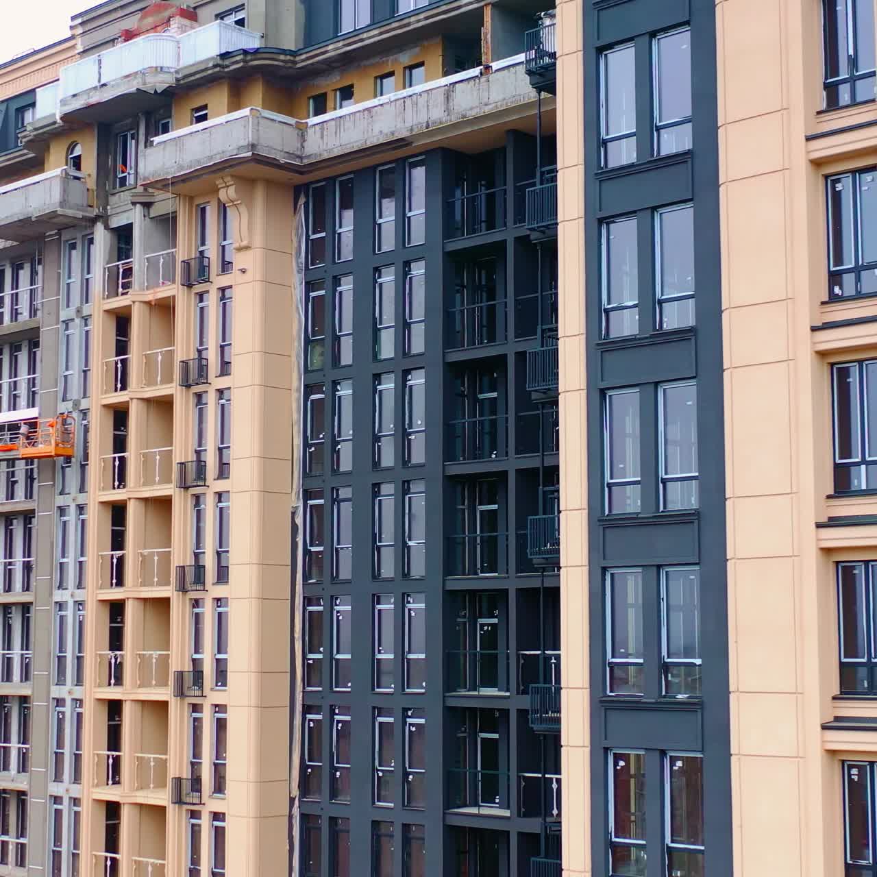 Construction of modern tower building. Exterior of a new architecture in the city. Building of high-rise house.