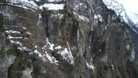 Klöntalersee-Switzerland-aerial-of-rocky-cliffs-mid-way-up